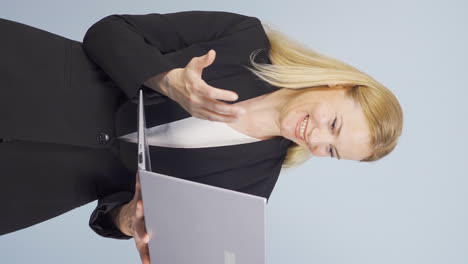 Vertical-video-of-Satisfied-business-woman-looks-at-laptop-and-approves.